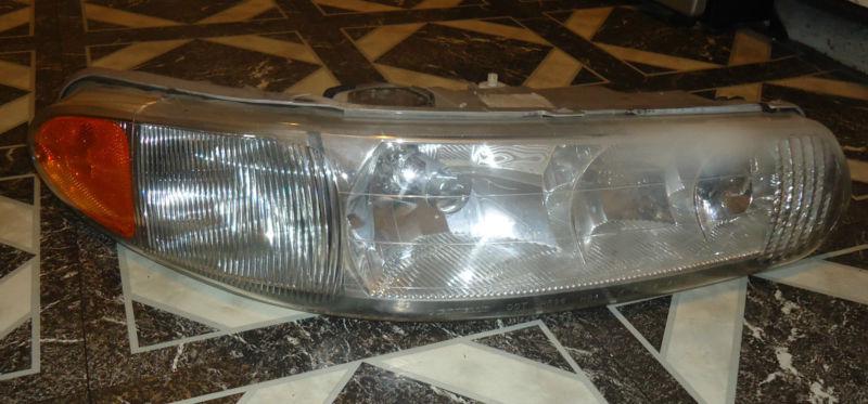 Passenger side  headlight assembly w/ bulbs 97-04 regal century cornering 