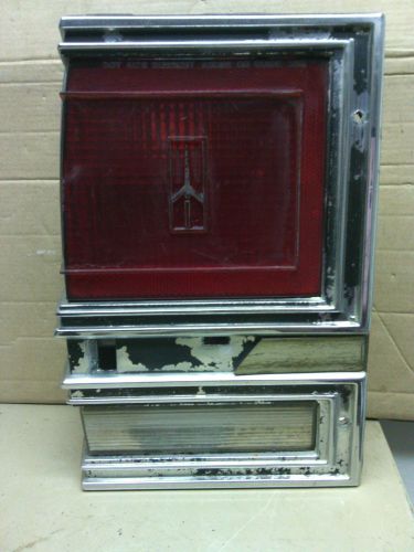 1980 - 1990  oldsmobile cutlass cruiser sw  lh tail light and chrome bezel  oem