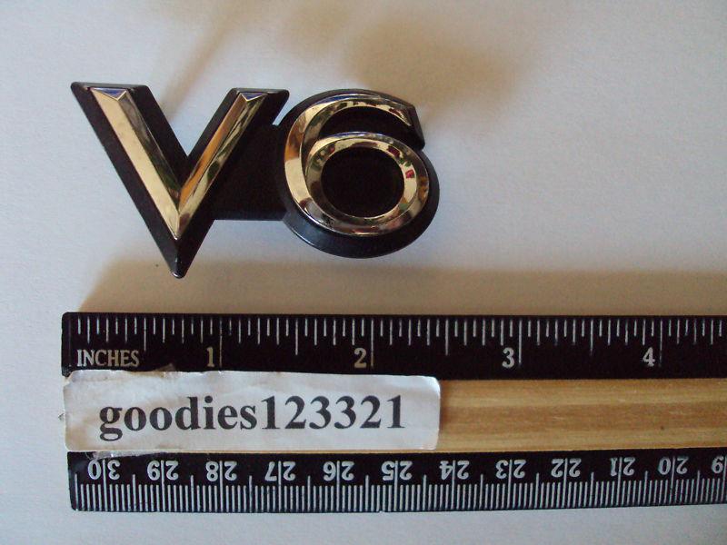 Toyota v6 black & chrome emblem used  2 1/4" x  1 1/2"