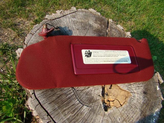 1993 cadillac lighted sun visor left side red.