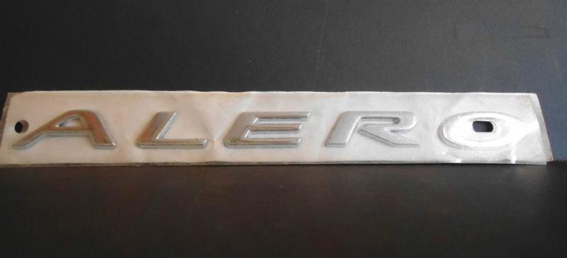 New genuine oem oldsmobile "alero" script emblem 8 1/8" x 9/16" chrome 22658173