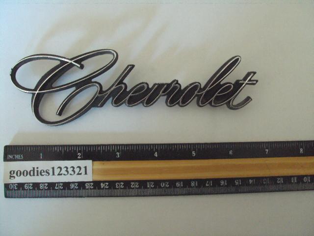 Chevrolet black and metal emblem # 9831025  used 6 1/2" x 2"