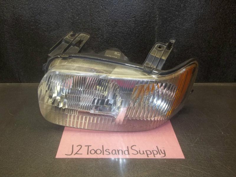 Used genuine ford 4l84-13006-aa headlamp