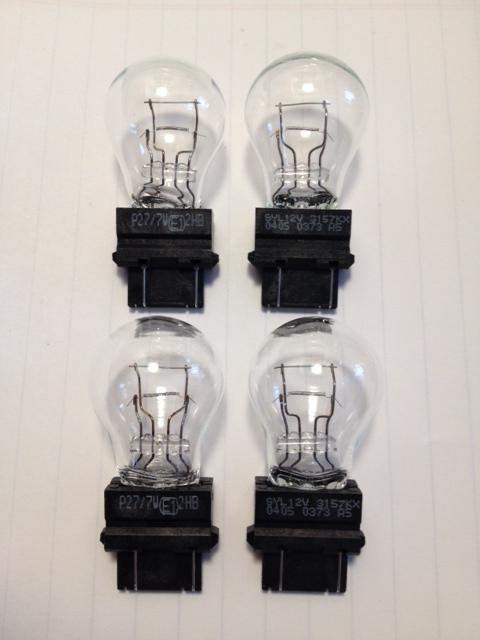 Sylvania 3157kx tail light/turn signal  **set of 4**. genuine oem quality