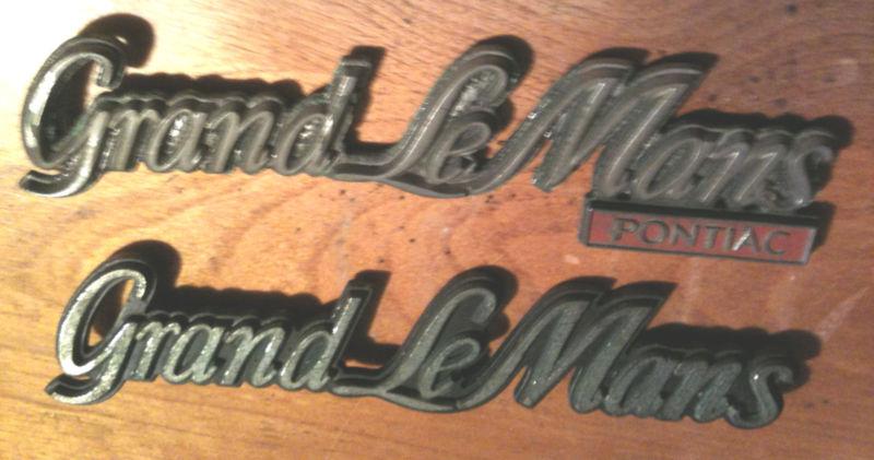 2 vintage grand lemans auto / car / truck plastic emblem - as is