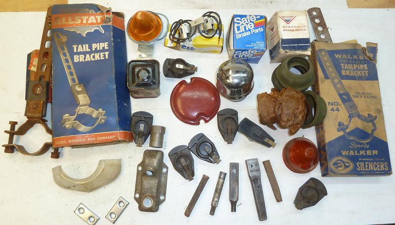 A small pile of misc. old car parts, a little model a ford and a lot of ????