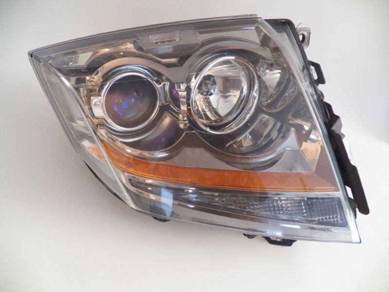 2011 cadillac sts left headlight part no. 25897357