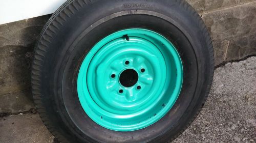 1957 chevy original spare wheel, and tire and hubcap .nice condition.