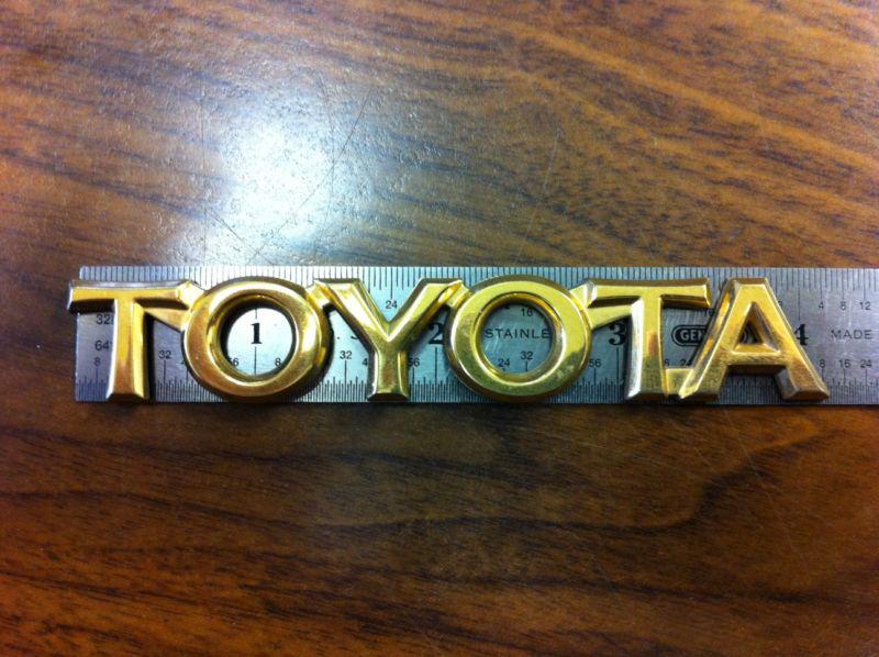 Gold toyota trunk emblem 4-1/4 x 11/16 excellent used condition