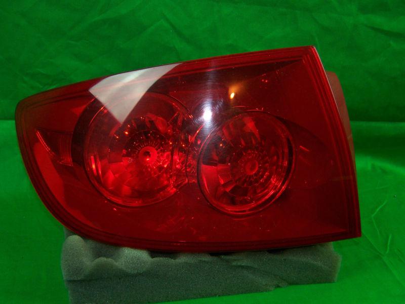 Used 2005 mazda 3 left side tail light with bulbs oem drivers side